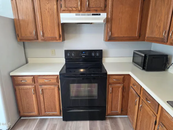 a stove top oven sitting inside of a kitchen