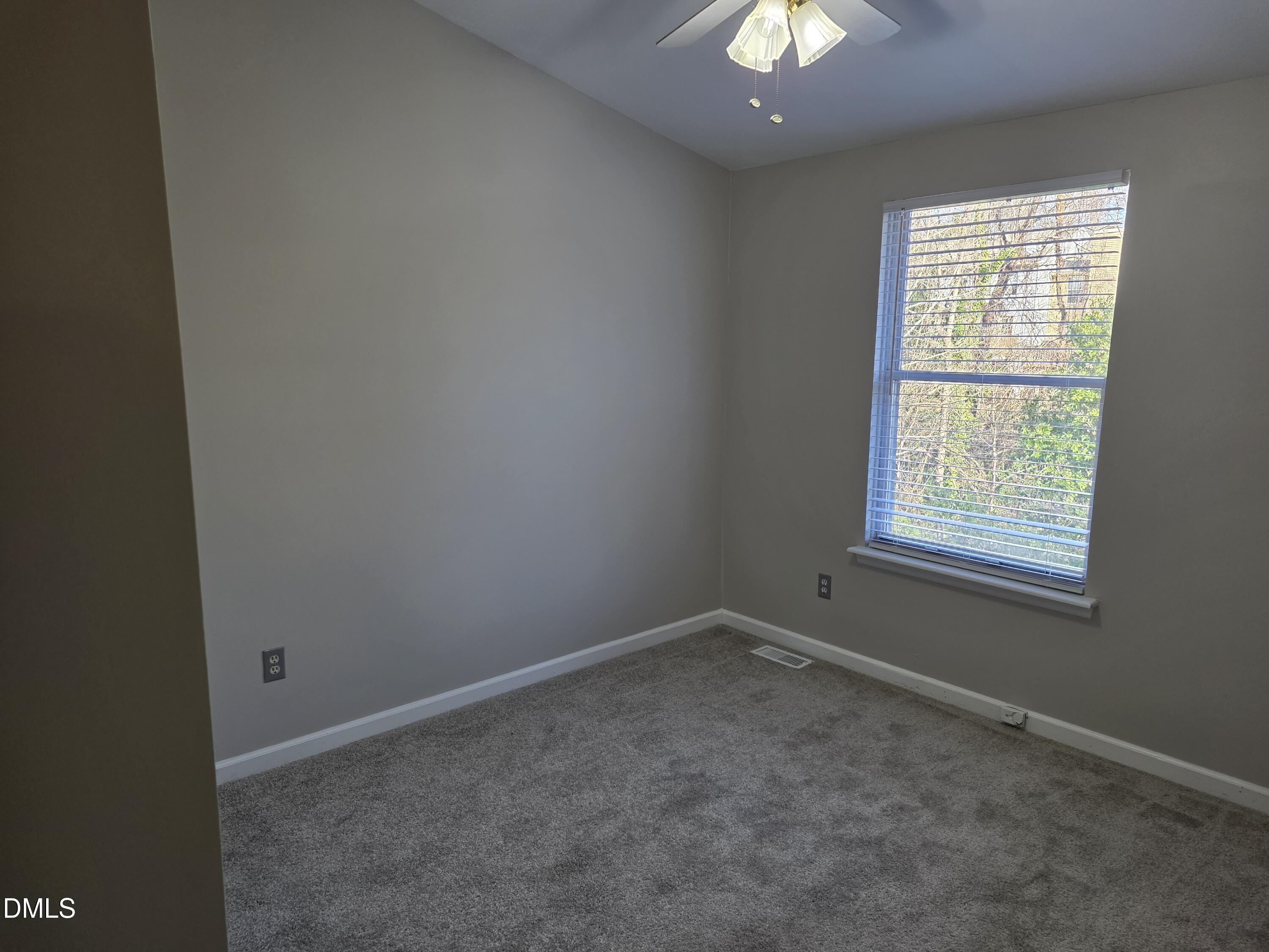 1717 Kayla Court Raleigh, NC 27606 - Photo 9 of 27 an empty room with a empty space and windows