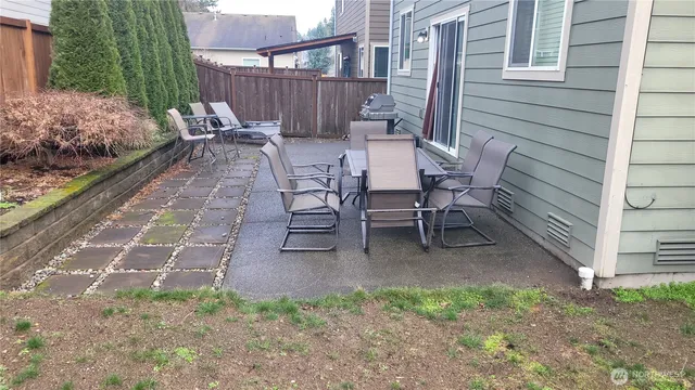 a view of a patio with a table and chairs