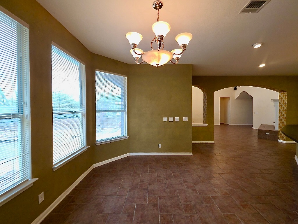 1103 Seton Hall Lane Pflugerville, TX 78660 - Photo 11 of 32 Breakfast area open to kitchen and living room with windows overlooking the backyard.