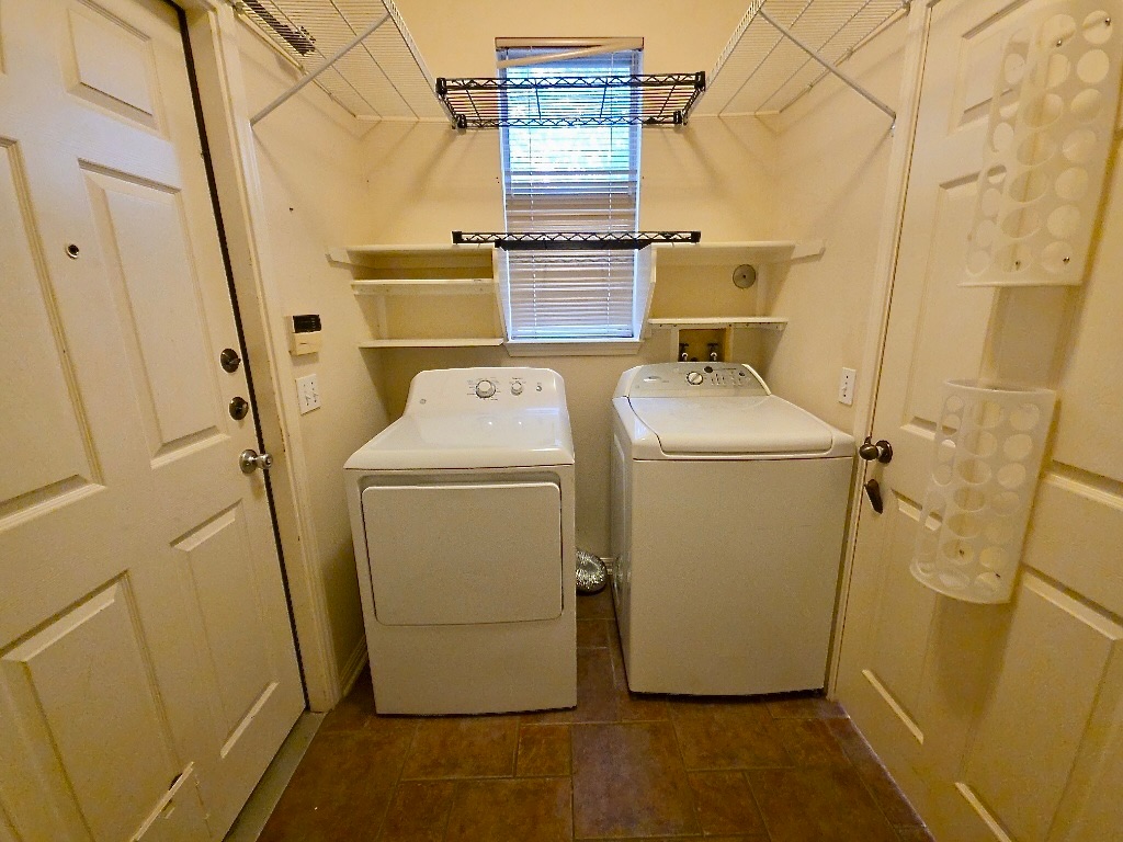 1103 Seton Hall Lane Pflugerville, TX 78660 - Photo 15 of 32 Laundry area with separate washer and dryer and dark tile patterned flooring