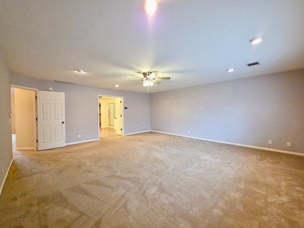 1103 Seton Hall Lane Pflugerville, TX 78660 - Photo 21 of 32 Primary bedroom with light carpet, recessed lighting, and ceiling fan