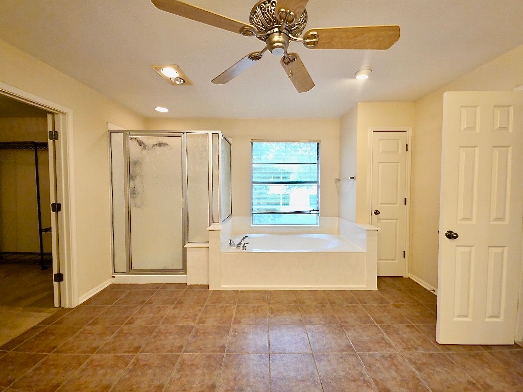 1103 Seton Hall Lane Pflugerville, TX 78660 - Photo 22 of 32 Full bathroom with a bath, a stall shower, ceiling fan, and tile patterned floors