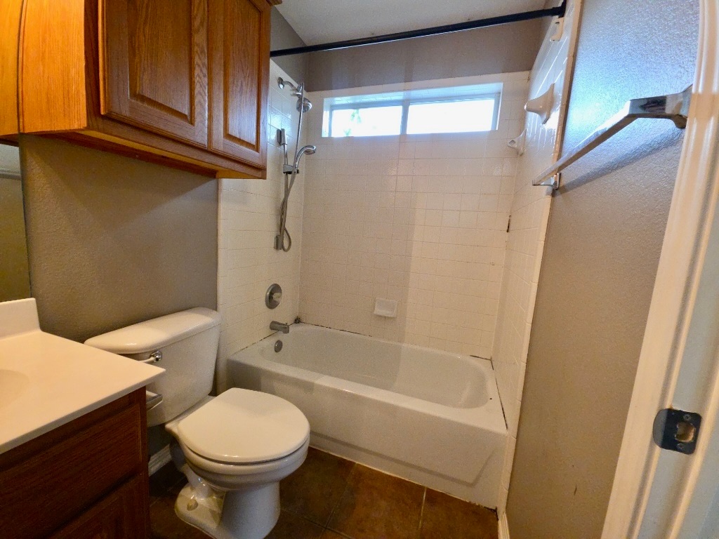 1103 Seton Hall Lane Pflugerville, TX 78660 - Photo 25 of 32 Bathroom featuring vanity, washtub / shower combination, and tile patterned floors