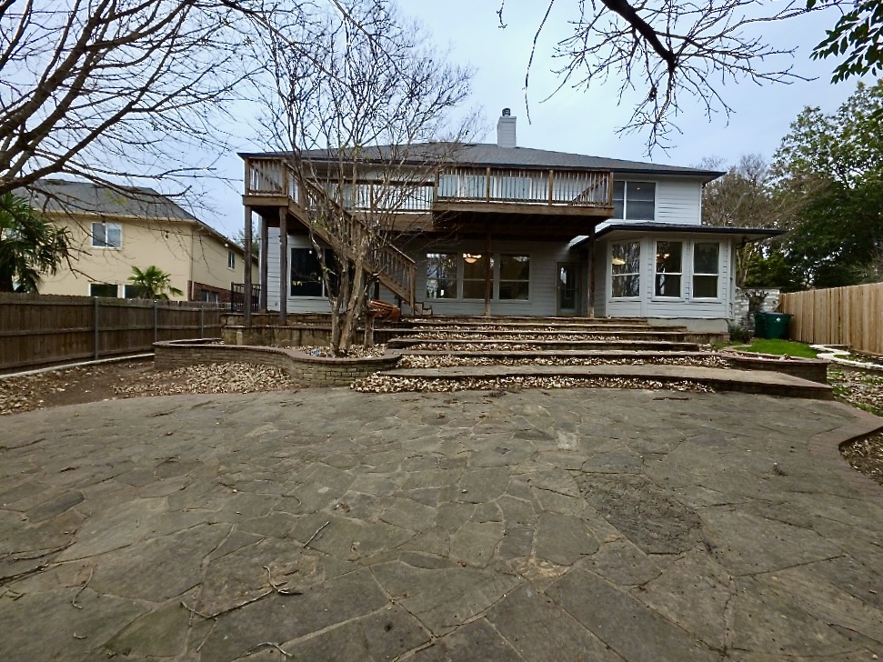 1103 Seton Hall Lane Pflugerville, TX 78660 - Photo 29 of 32 Rear view of house with a fenced backyard, a patio area, stairs, a chimney, deck, an second story balcony