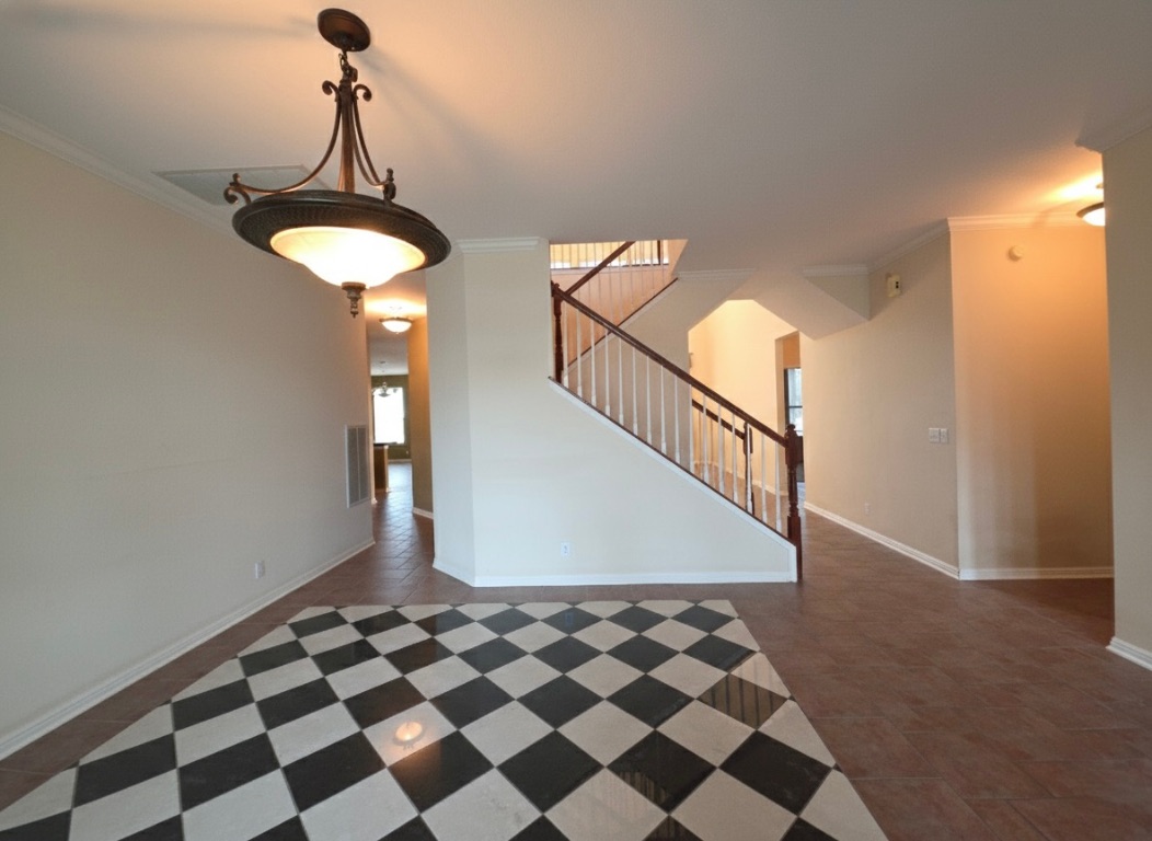 1103 Seton Hall Lane Pflugerville, TX 78660 - Photo 5 of 32 Formal dining room featuring crown molding and stairs