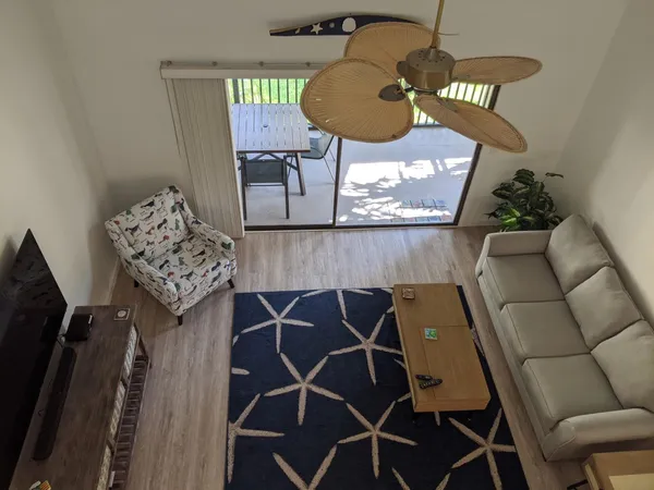 a picture of a room with furniture and wooden floor