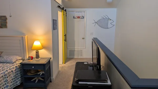a view of a hallway with furniture and staircase