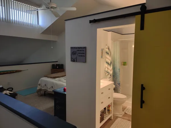 a en suite bathroom with a granite countertop sink and a mirror