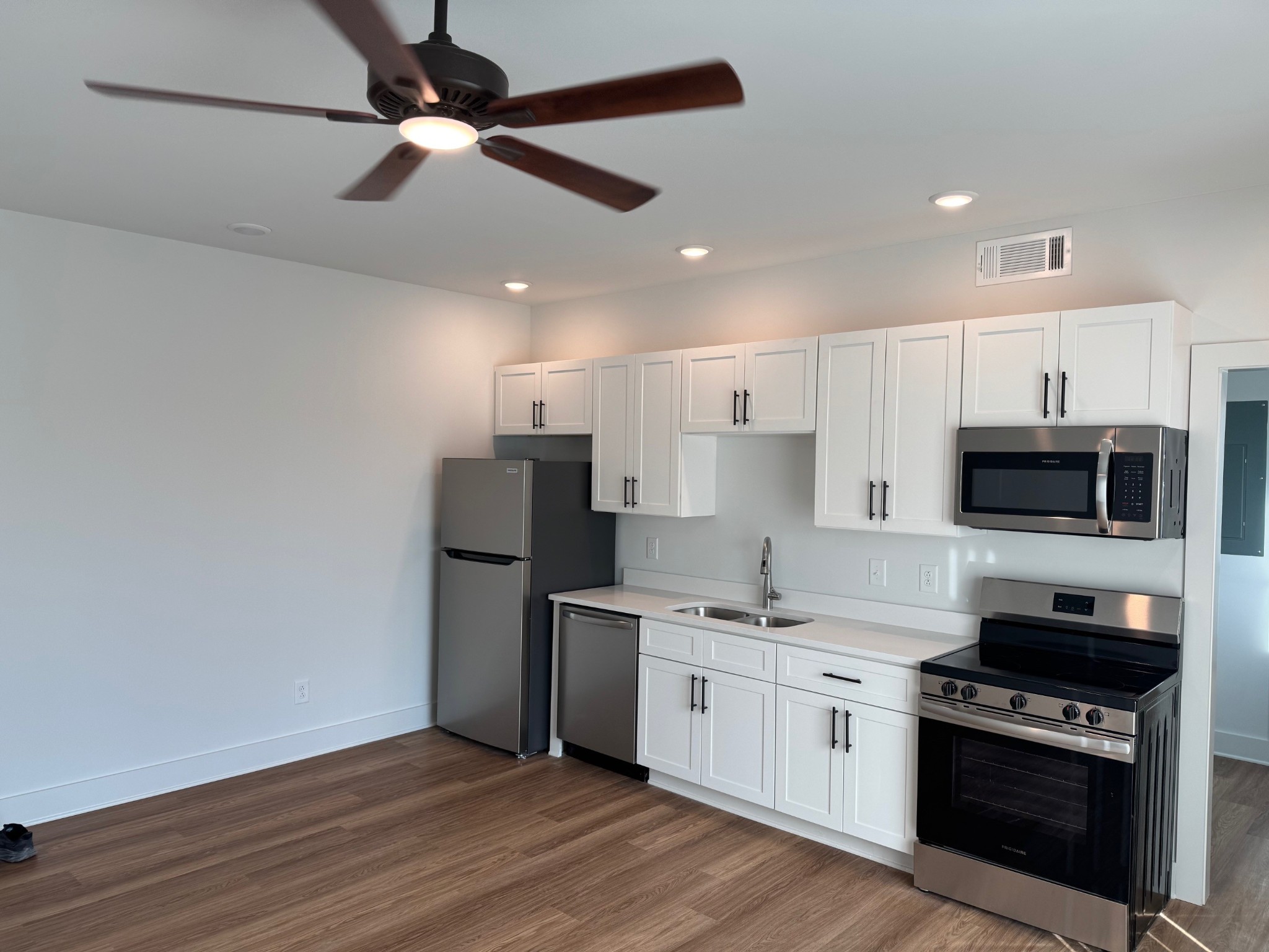 3000 Edwin Way, Unit 104 Nashville, TN 37207 - Photo 7 of 11 a kitchen with a sink stainless steel appliances and white cabinets