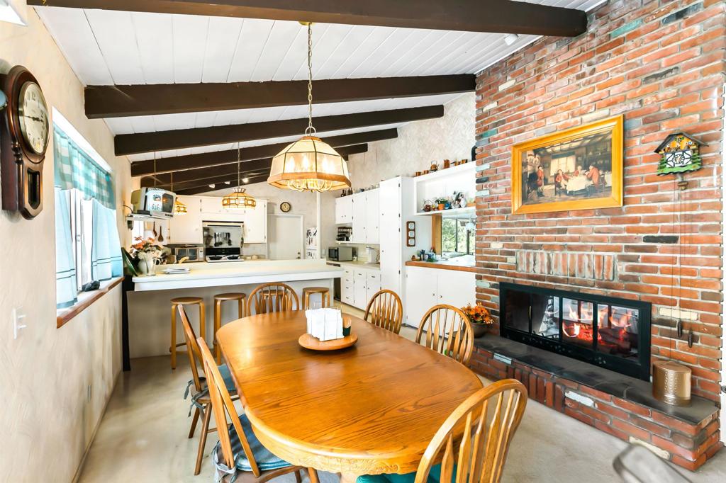 28721 Lebanon Road Pine Valley, CA 91962 - Photo 22 of 48 a dining room with furniture a fireplace and wooden floor