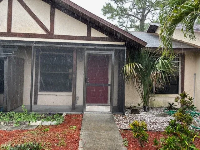 a couple of potted plants in front of door