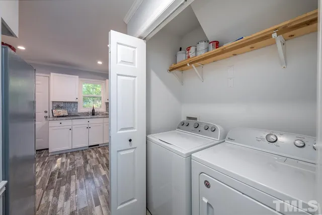 a view of washer and dryer with kitchen in the background