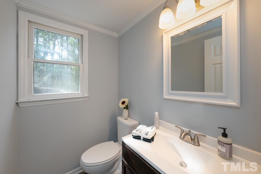 507 Valley Drive Durham, NC 27704 - Photo 15 of 29 a bathroom with a sink a toilet and a window