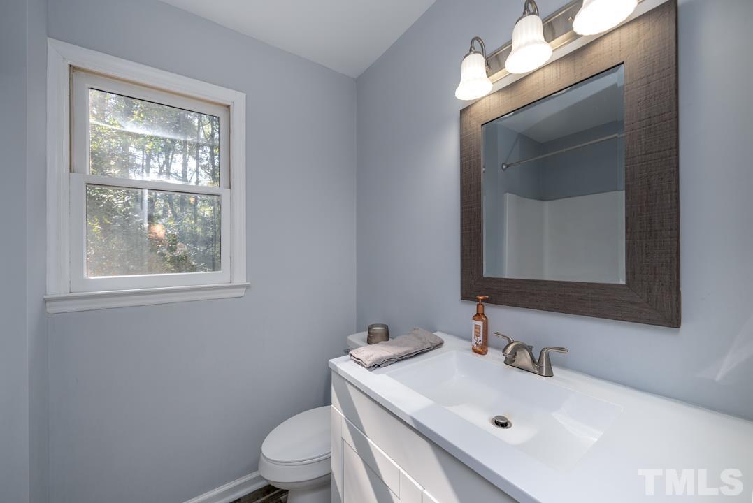 507 Valley Drive Durham, NC 27704 - Photo 19 of 29 a bathroom with a sink vanity mirror and toilet