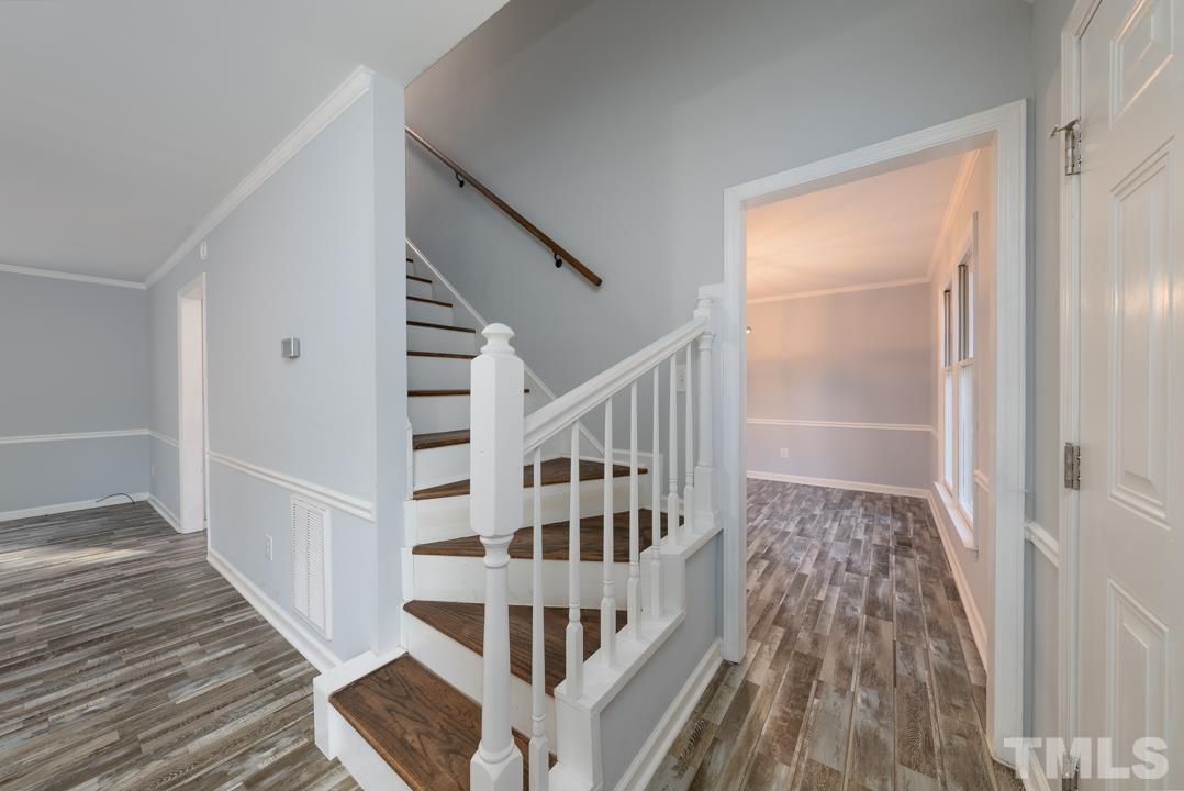 507 Valley Drive Durham, NC 27704 - Photo 4 of 29 a view of a balcony with wooden floor and stairs