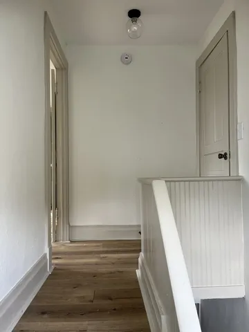 a view of staircase with white walls and window