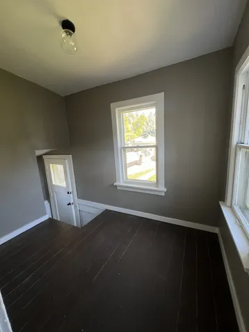 a view of an empty room with a fireplace