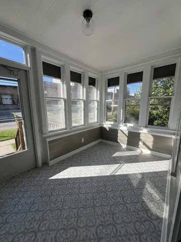 a kitchen with stainless steel appliances granite countertop a sink a stove a refrigerator cabinets and a window