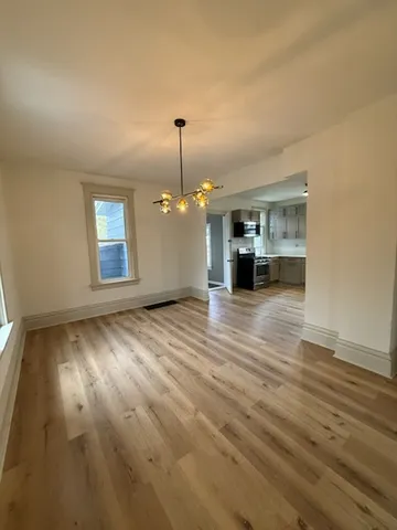 an empty room with wooden floor wooden floor and windows