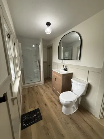 a bathroom with a toilet sink and mirror