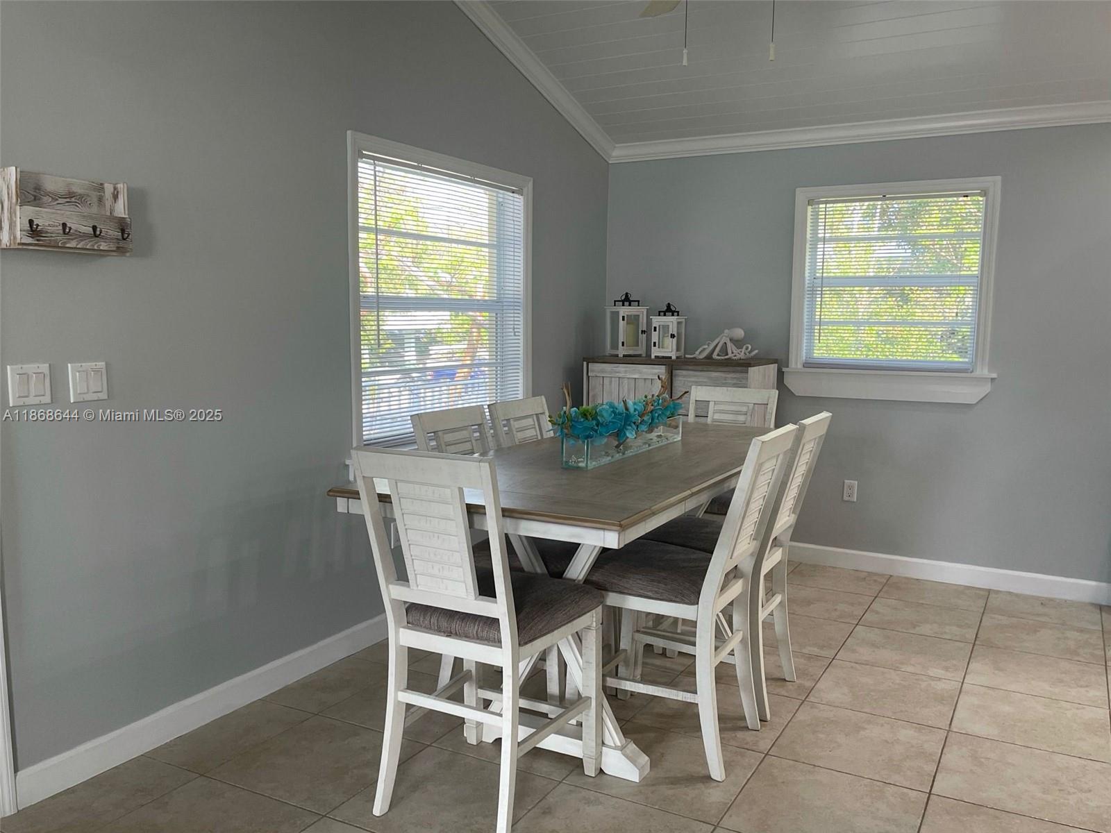 1013 Snapper Lane Key Largo, FL 33037 - Photo 4 of 10 a view of a dining room with furniture and window
