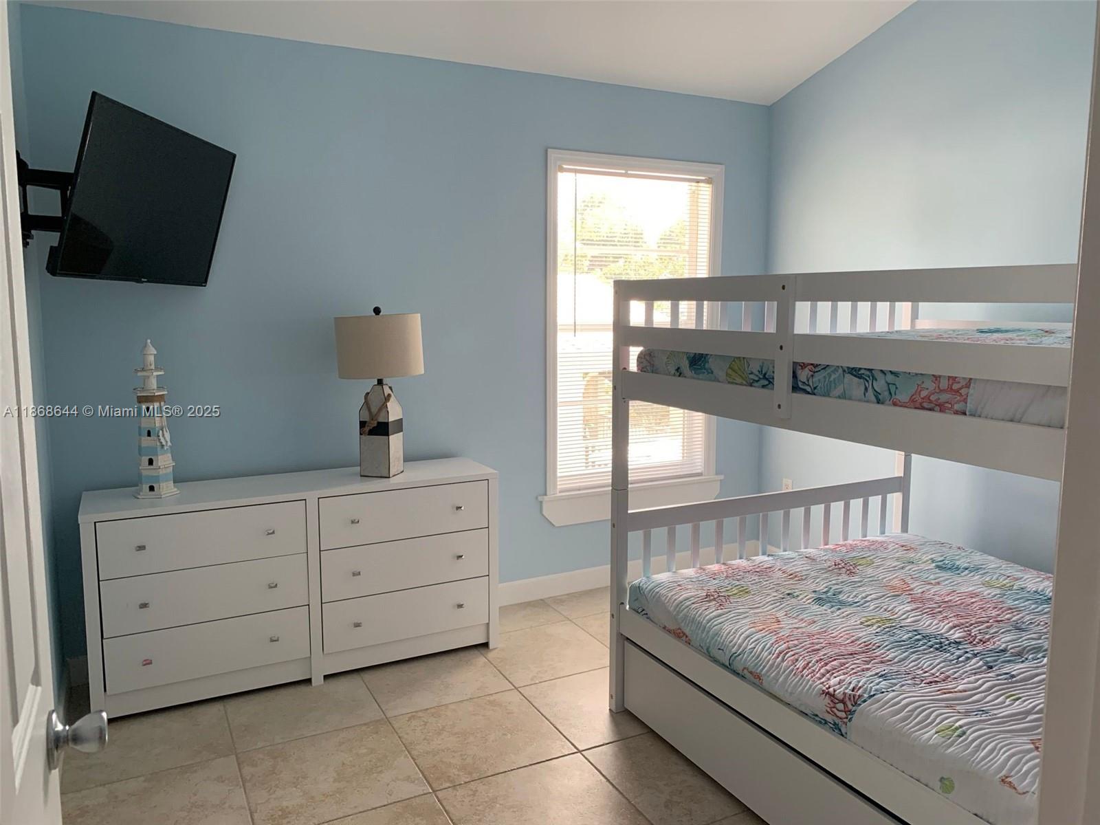 1013 Snapper Lane Key Largo, FL 33037 - Photo 5 of 10 a living room with furniture and a flat screen tv