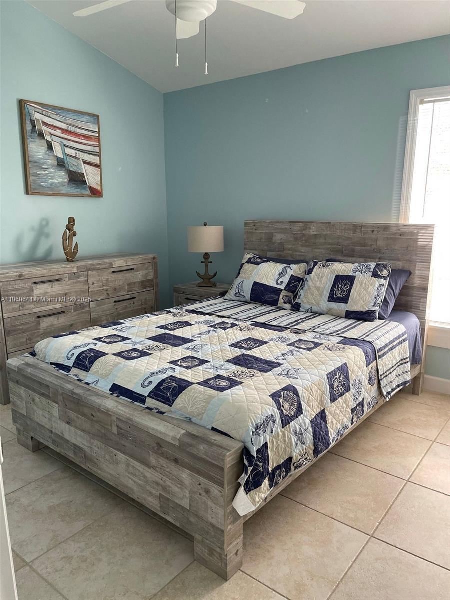 1013 Snapper Lane Key Largo, FL 33037 - Photo 7 of 10 a bedroom with bed and window