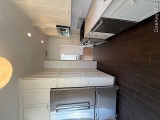 733 East Walnut Street, Unit UPPR Long Beach, NY 11561 - Photo 10 of 26 a kitchen with a refrigerator a stove top oven and a sink