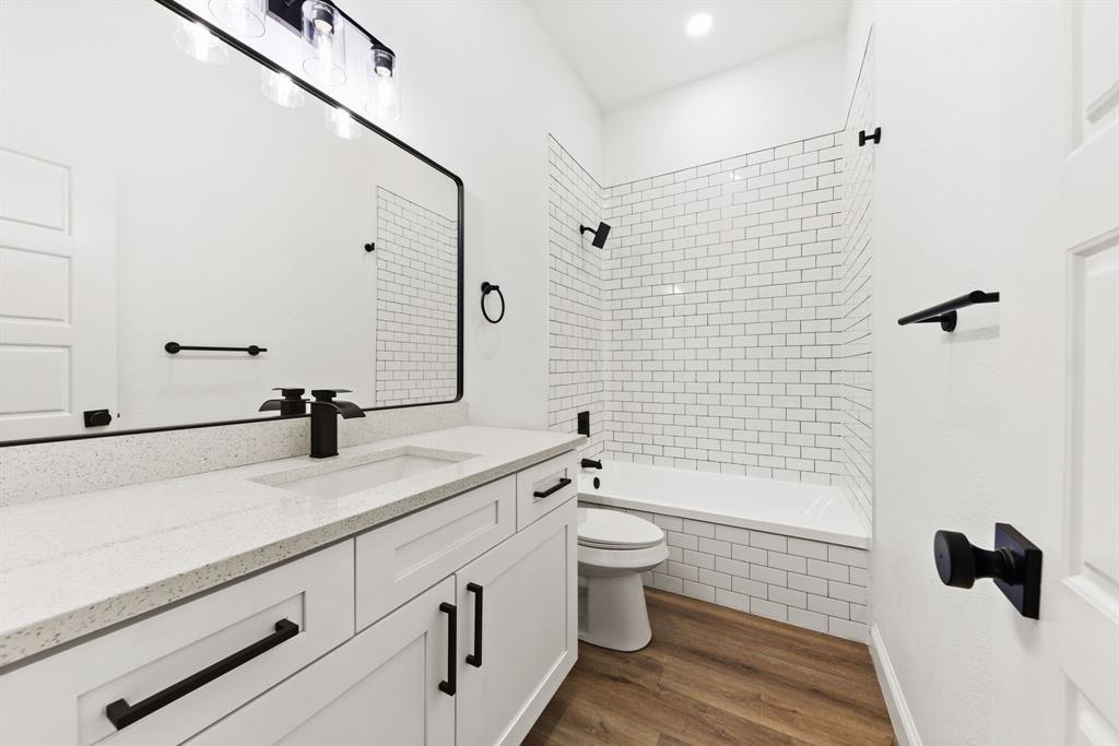 1279 Bonham Street Paris, TX 75460 - Photo 11 of 15 a bathroom with a sink a toilet and shower