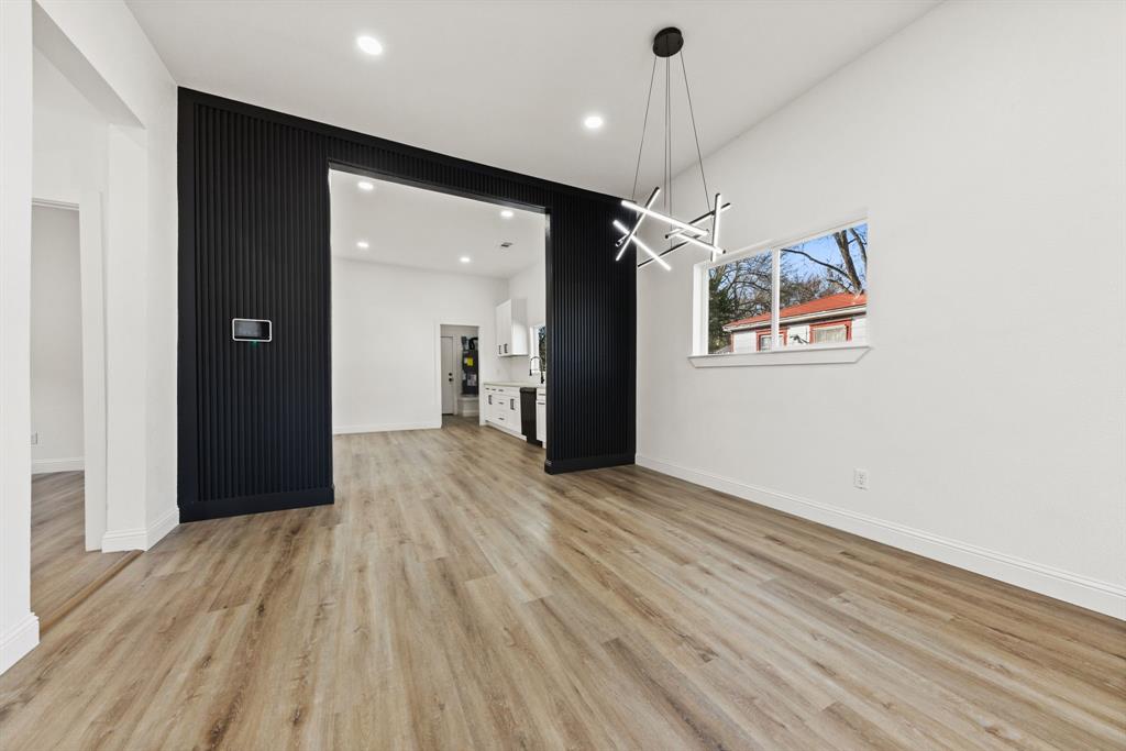 1279 Bonham Street Paris, TX 75460 - Photo 5 of 15 an empty room with wooden floor and windows