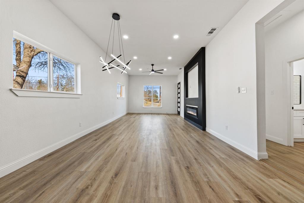 1279 Bonham Street Paris, TX 75460 - Photo 6 of 15 wooden floor in an empty room with a window