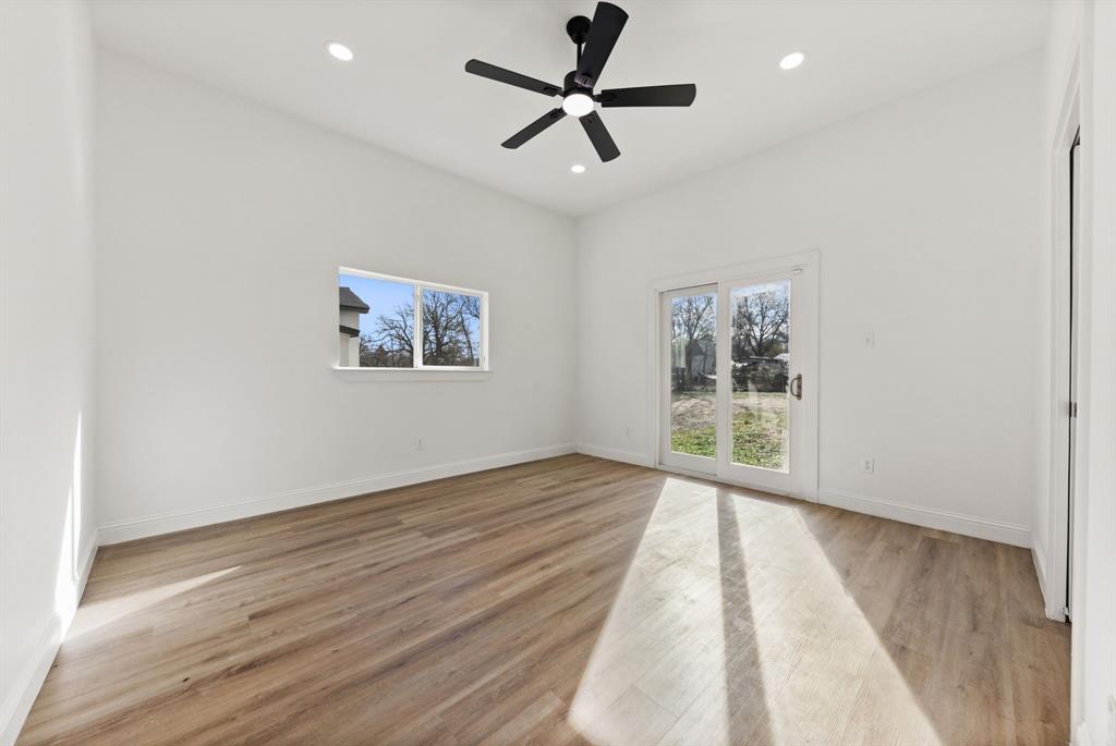 1279 Bonham Street Paris, TX 75460 - Photo 8 of 15 wooden floor in an empty room with a window