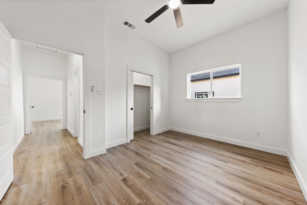 1279 Bonham Street Paris, TX 75460 - Photo 10 of 15 a view of an empty room with wooden floor