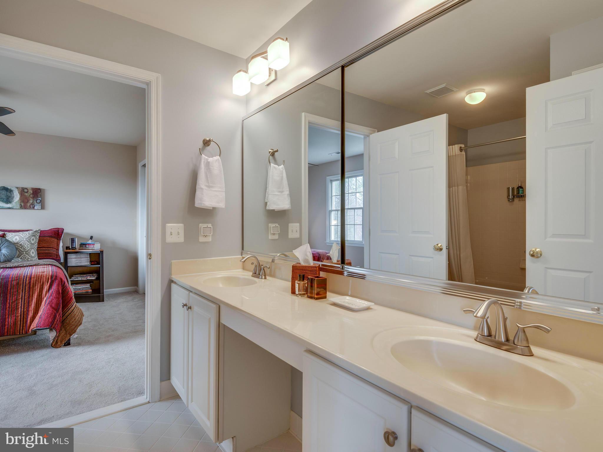 10889 Hunter Gate Way Reston, VA 20194 - Photo 22 of 30 a bathroom with a sink double vanity and a mirror