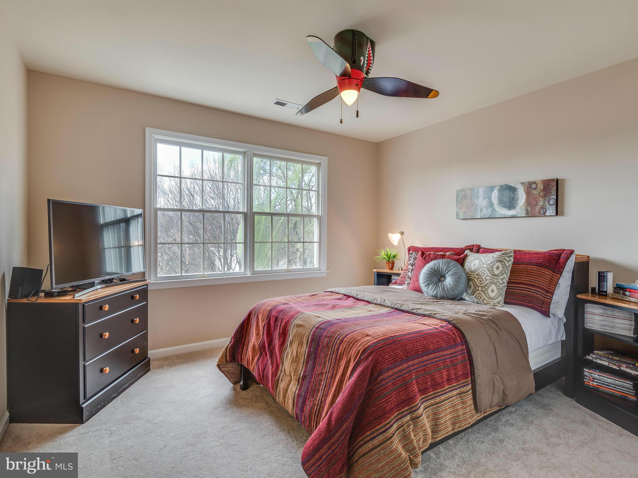 10889 Hunter Gate Way Reston, VA 20194 - Photo 23 of 30 a bedroom with a bed and a flat screen tv