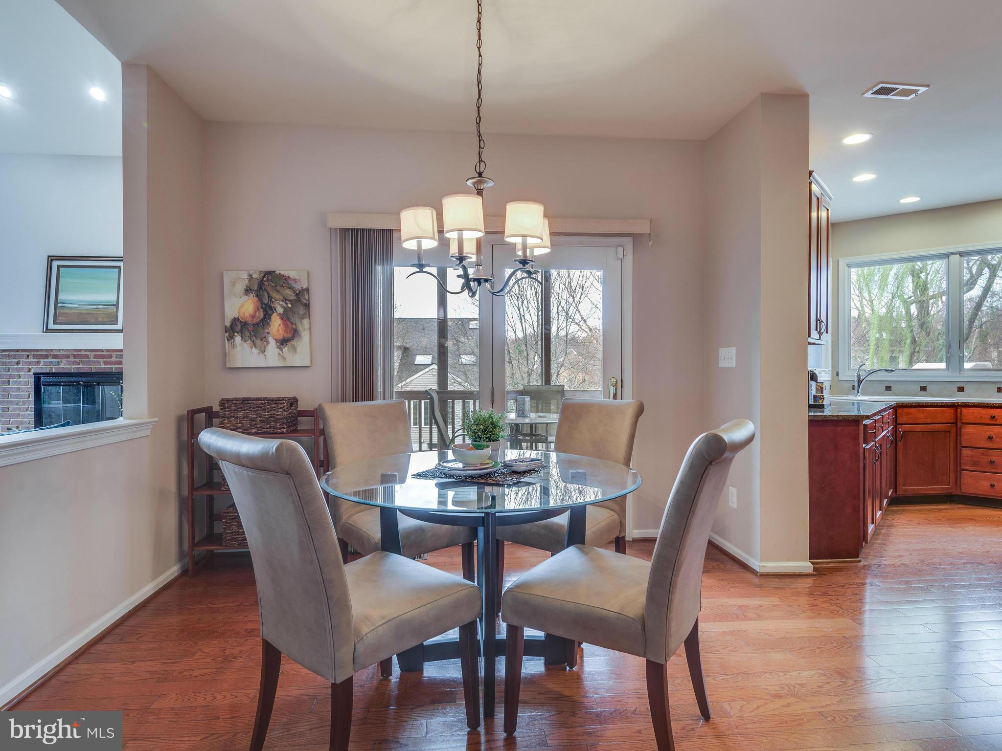 10889 Hunter Gate Way Reston, VA 20194 - Photo 5 of 30 a dining room with furniture a chandelier and wooden floor