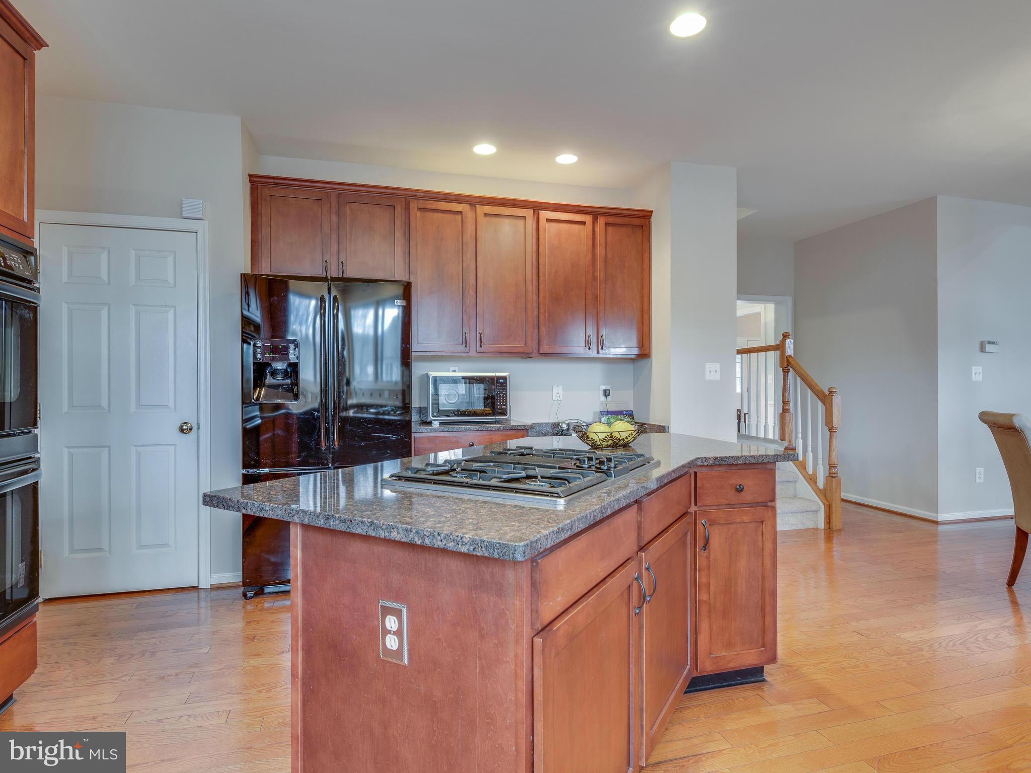 10889 Hunter Gate Way Reston, VA 20194 - Photo 8 of 30 a kitchen with stainless steel appliances granite countertop a sink stove and refrigerator