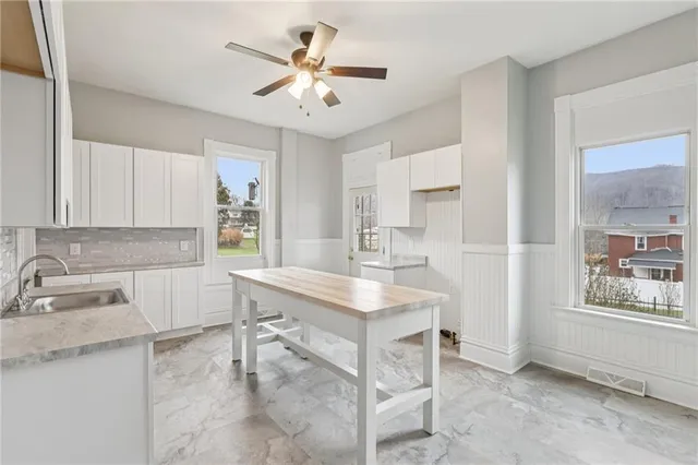 a view of a kitchen with a sink and cabinets