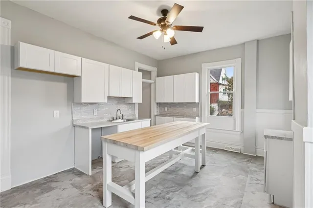 a kitchen with a stove a sink and cabinets