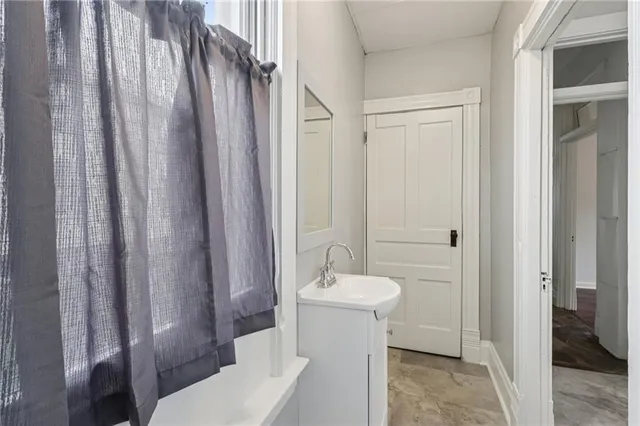 a view of a hallway with wooden floor and entryway