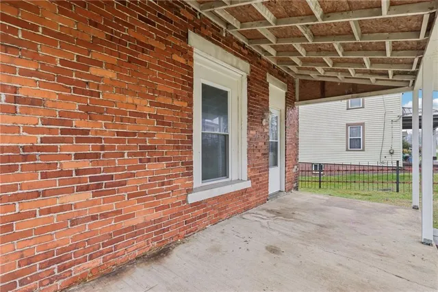 a view of a hallway with wooden floor and entryway