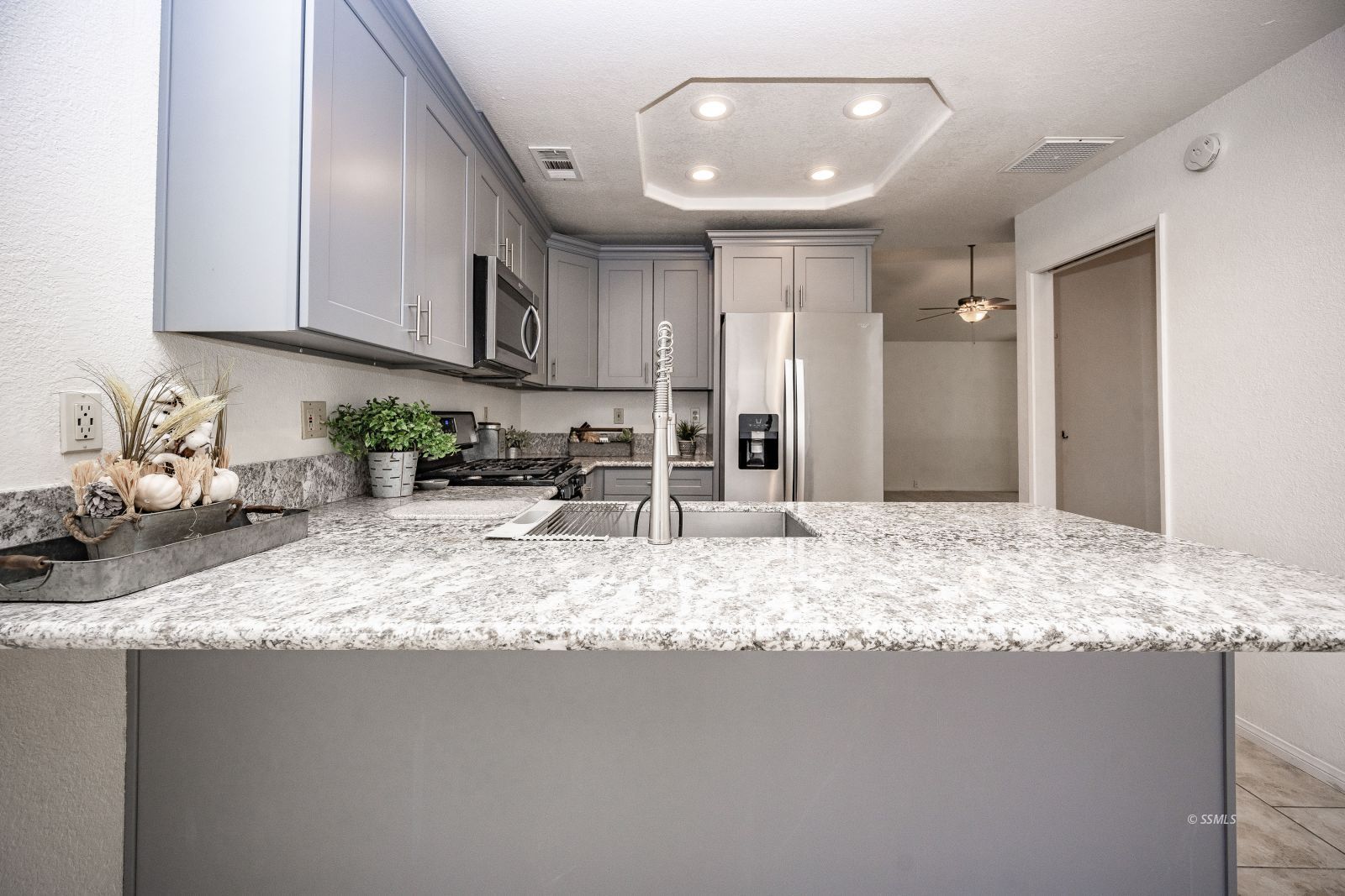 704 Beth Lane Ridgecrest, CA 93555 - Photo 12 of 39 a kitchen with stainless steel appliances granite countertop a sink refrigerator and cabinets