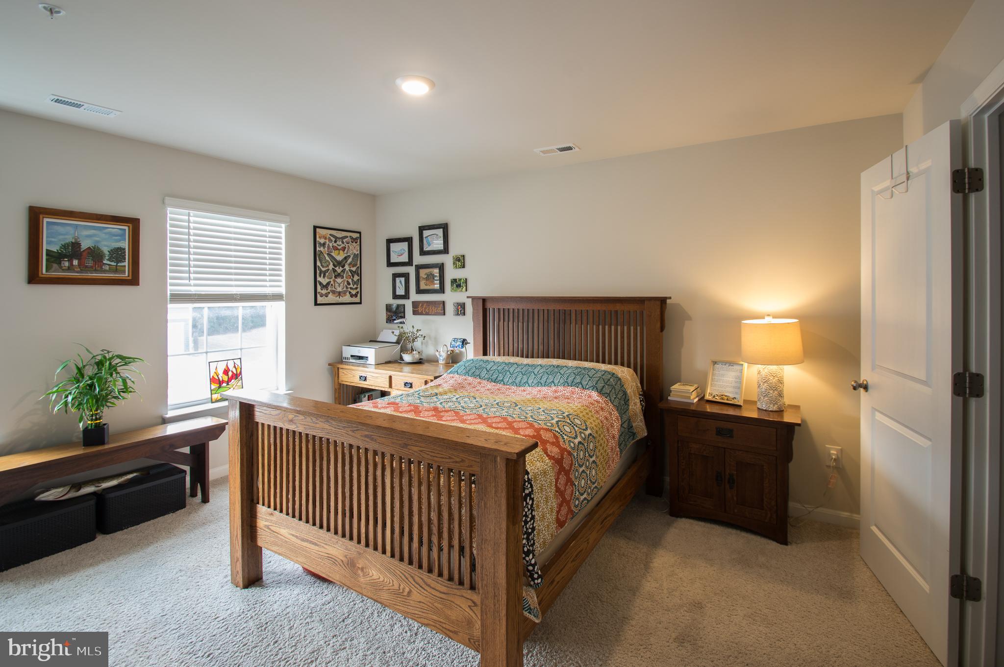 345 Maple Run Drive York, PA 17404 - Photo 13 of 26 a bedroom with a bed and a potted plant on dresser