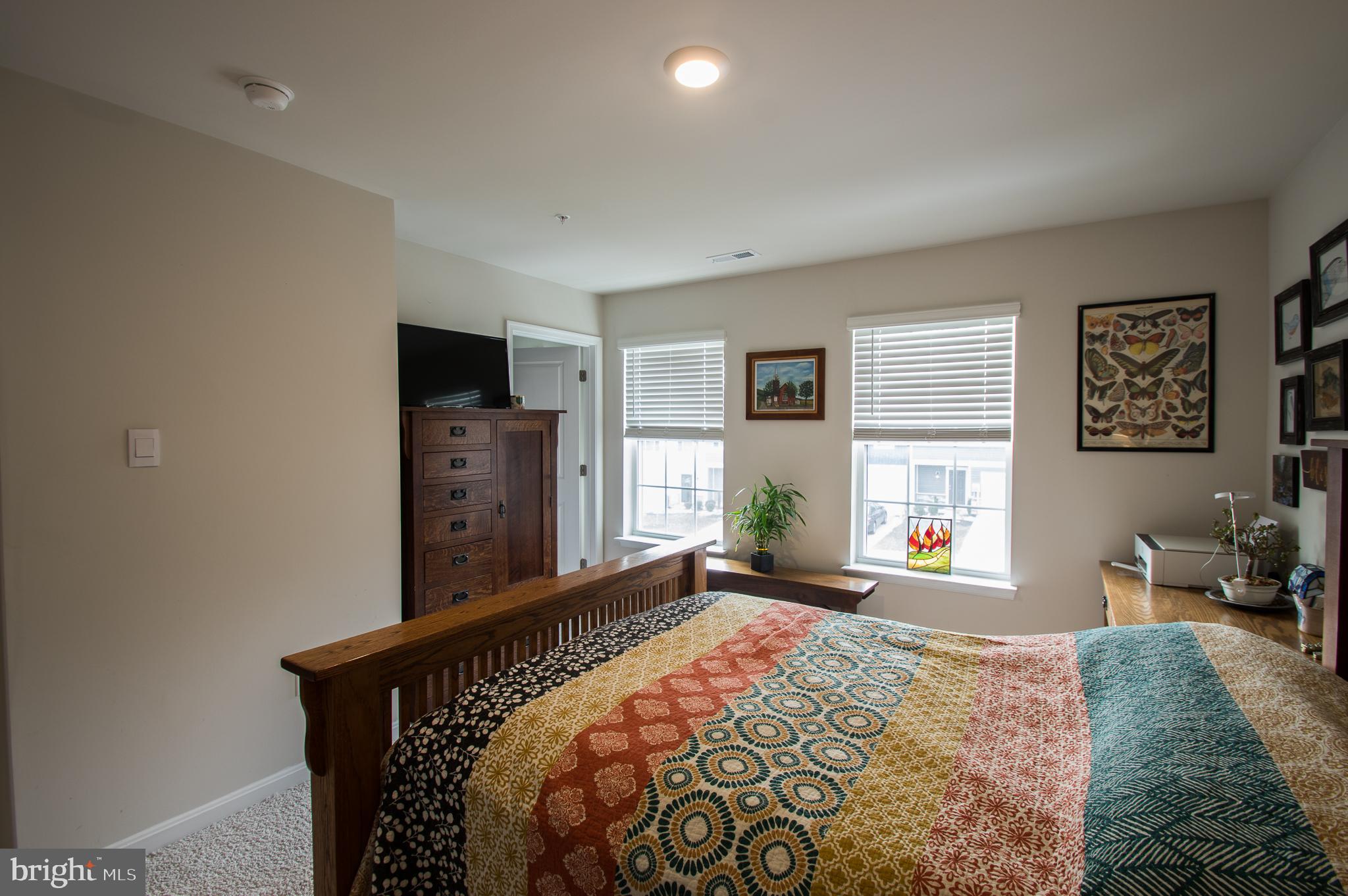 345 Maple Run Drive York, PA 17404 - Photo 14 of 26 a bed sitting in a spacious bedroom next to a window and dresser