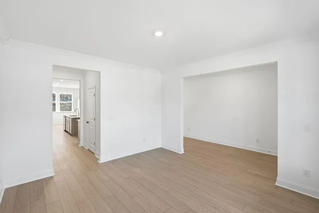 a view of a room with wooden floor