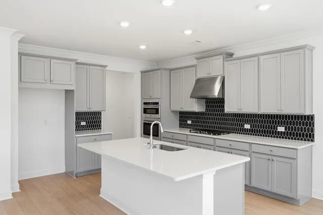 a kitchen with a sink dishwasher a stove and a refrigerator