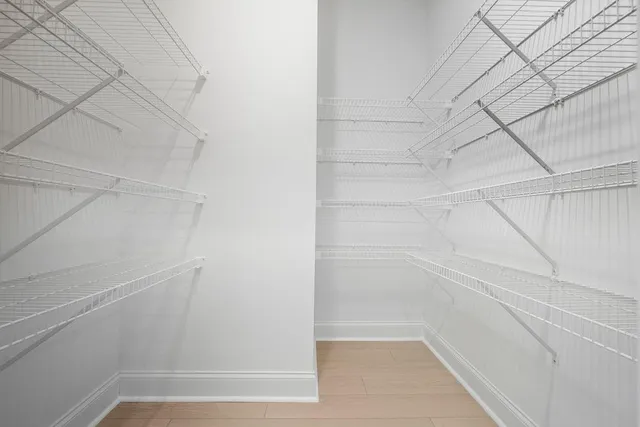 a view of an empty room with a window and fireplace