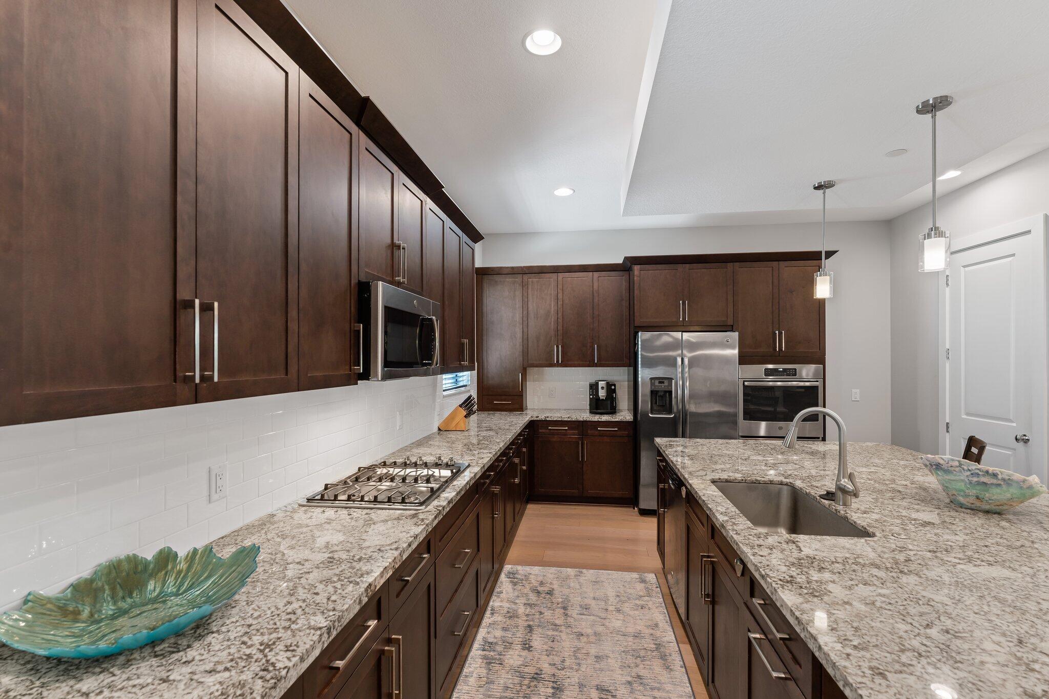 13364 Alton Road Palm Beach Gardens, FL 33418 - Photo 15 of 58 a large kitchen with granite countertop lots of counter top space