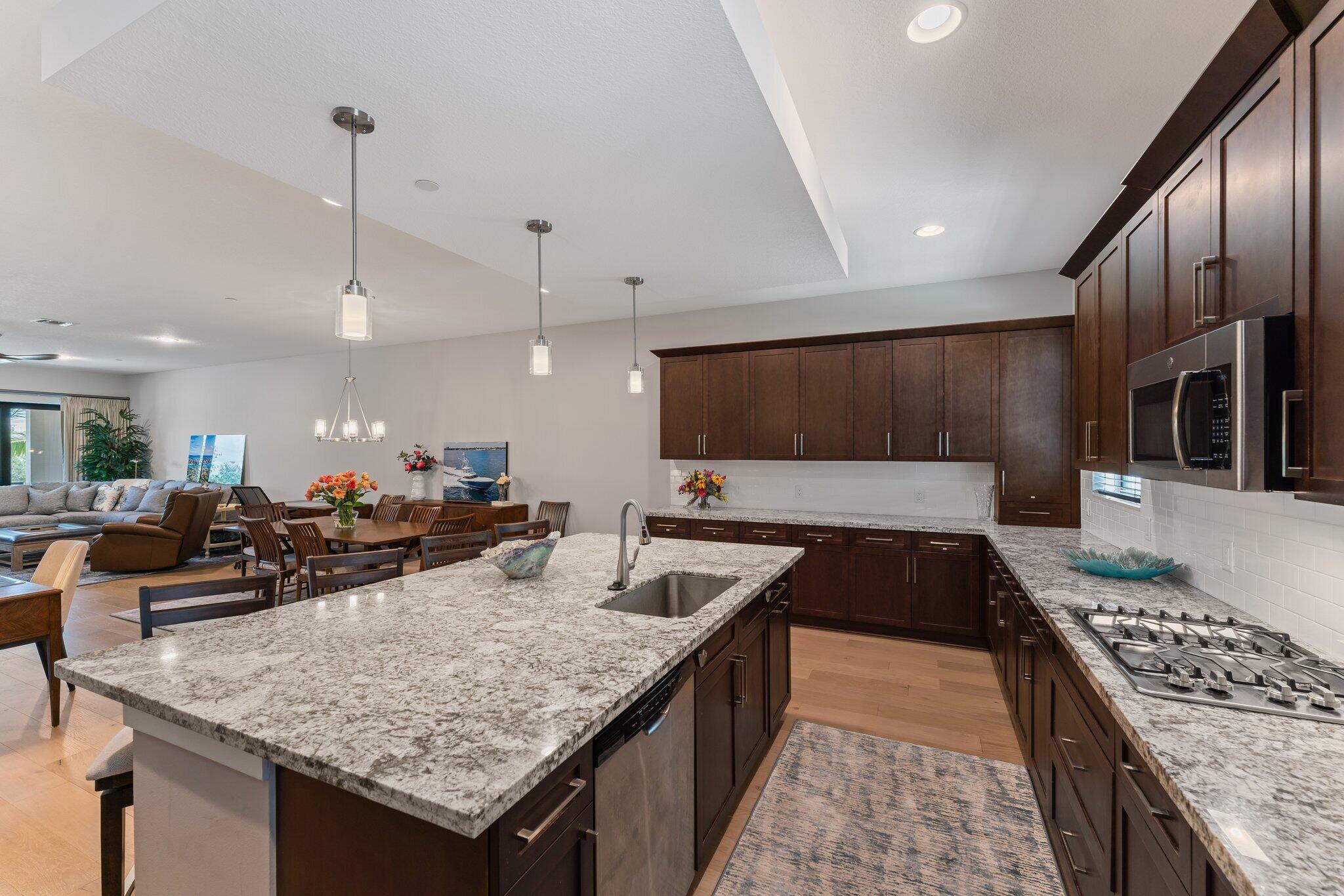13364 Alton Road Palm Beach Gardens, FL 33418 - Photo 16 of 58 a kitchen with kitchen island granite countertop a sink and counter space